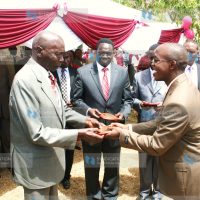 Former President Daniel Arap Moi presents a trophy to the top national KCSE student in the 2010 exams