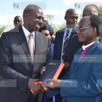 Deputy President Dr William Ruto receives a Kitharaka language bible from retired Kenya Methodist Church presiding bishop Dr Stephen Kanyaru