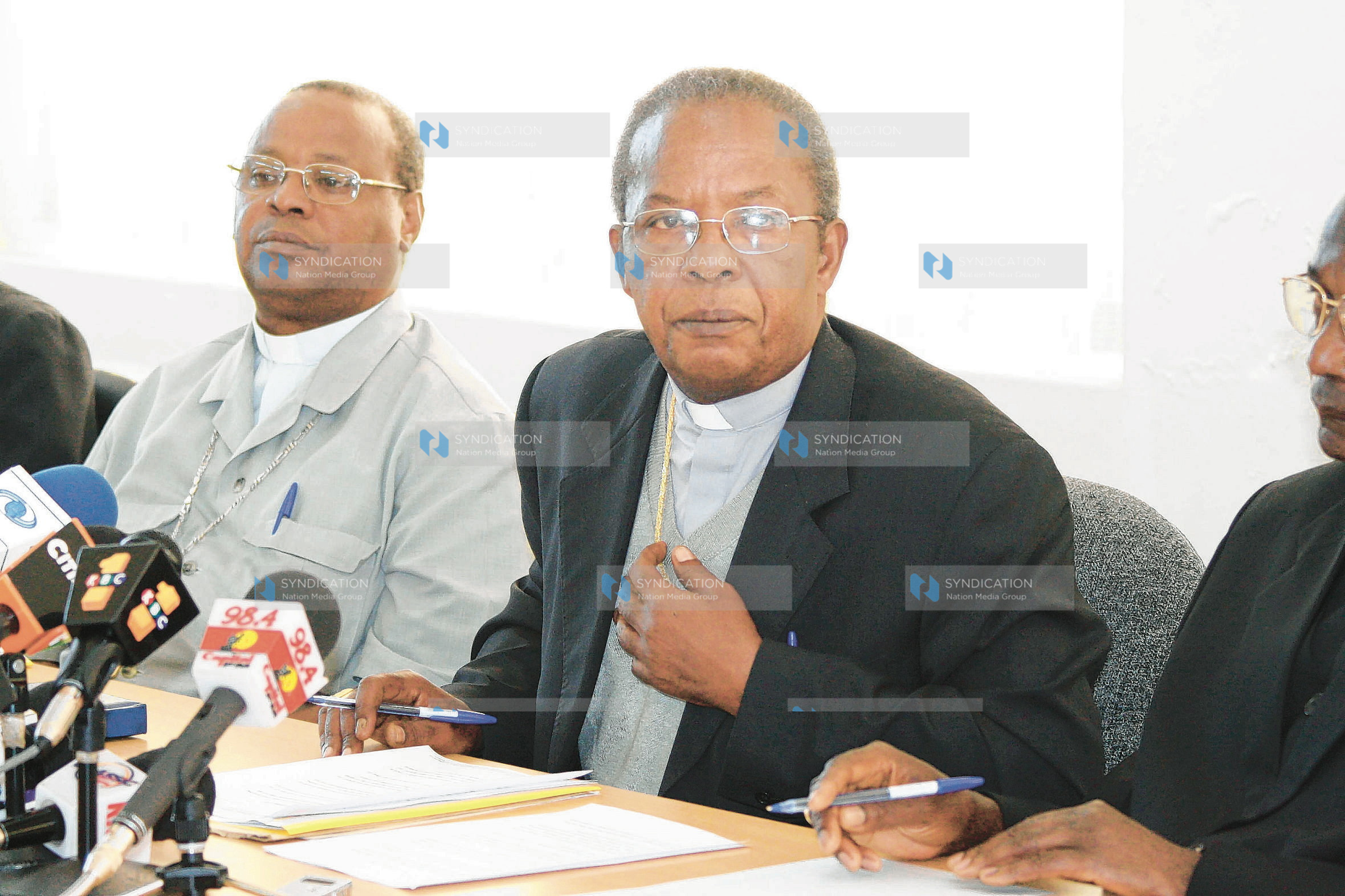 John Cardinal Njue (centre) addresses the press