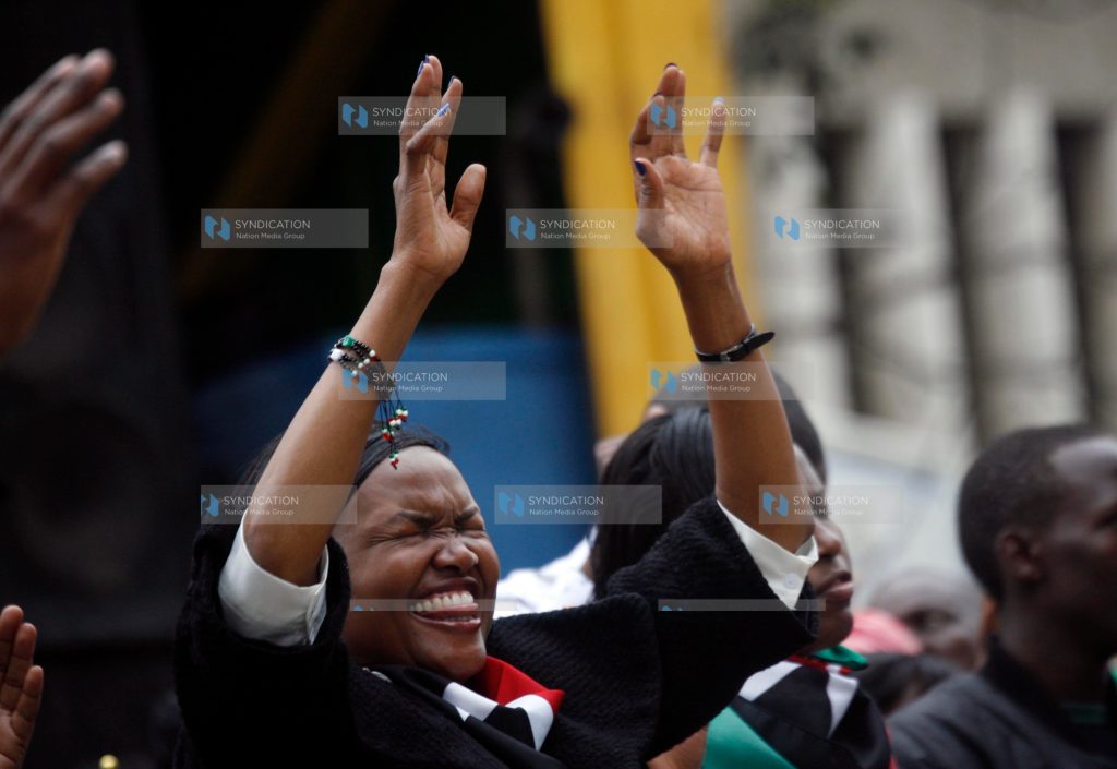 A woman prays at Uhuru Park Grounds in Nairobi