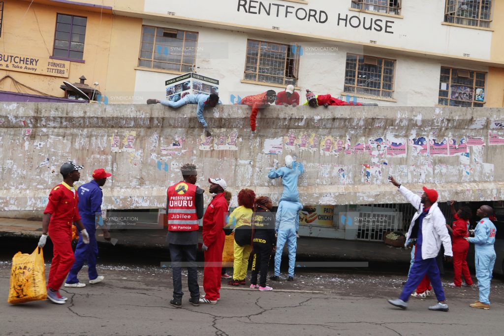 Sonko Rescue Team clean up posters left from the campaign season