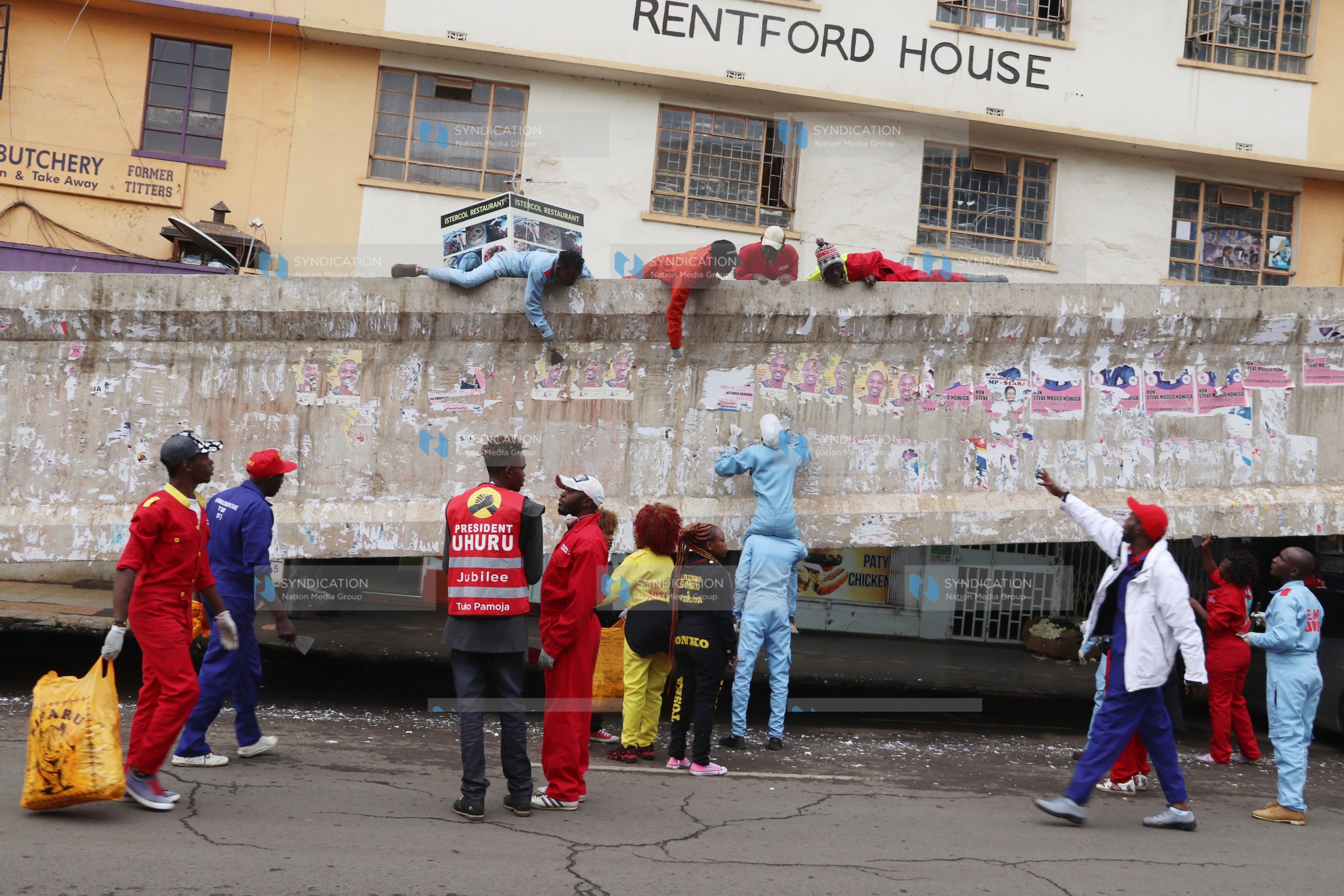 Sonko Rescue Team clean up posters left from the campaign season