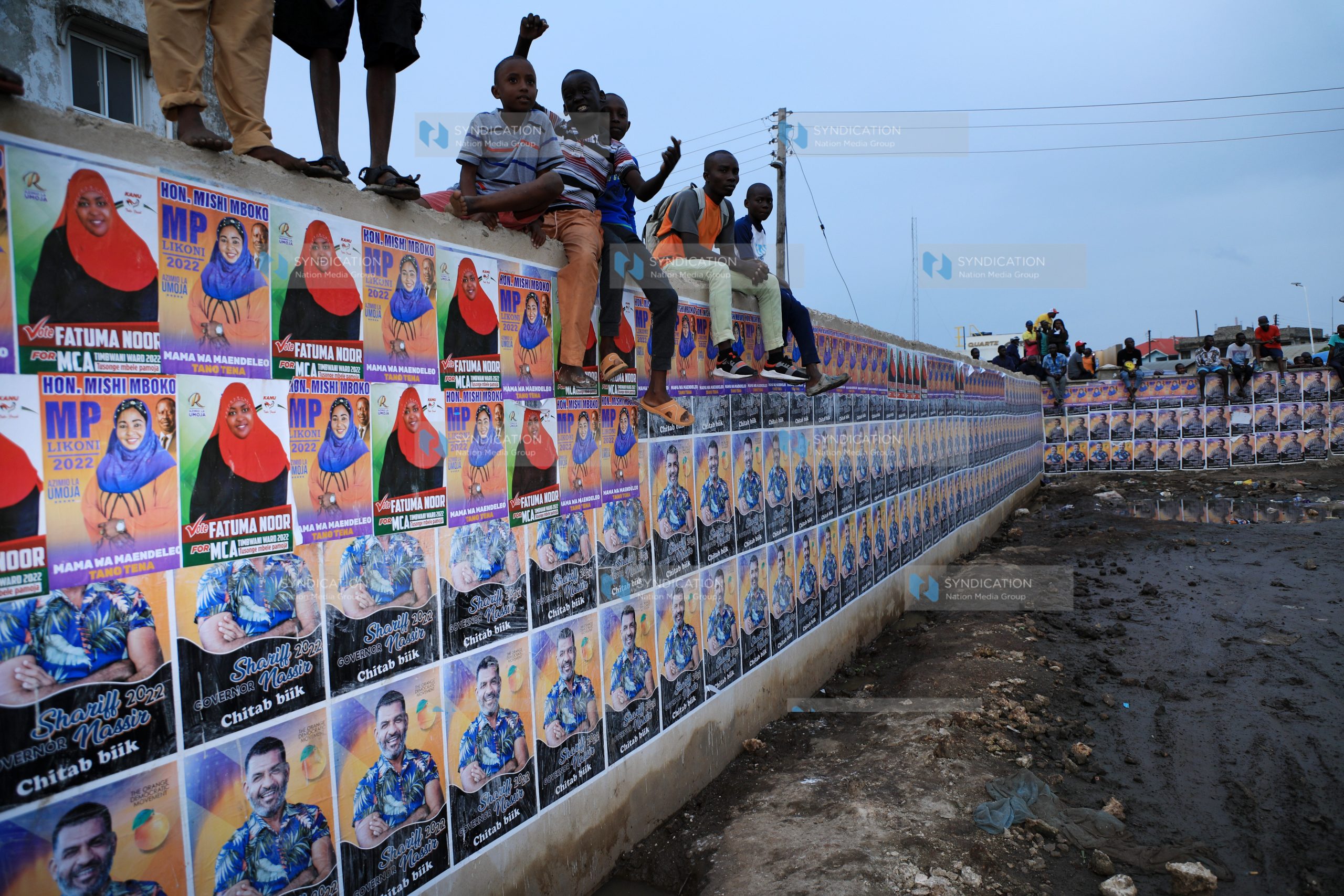 Campaign posters fill a wall at Caltex Grounds in Likoni, Mombasa County