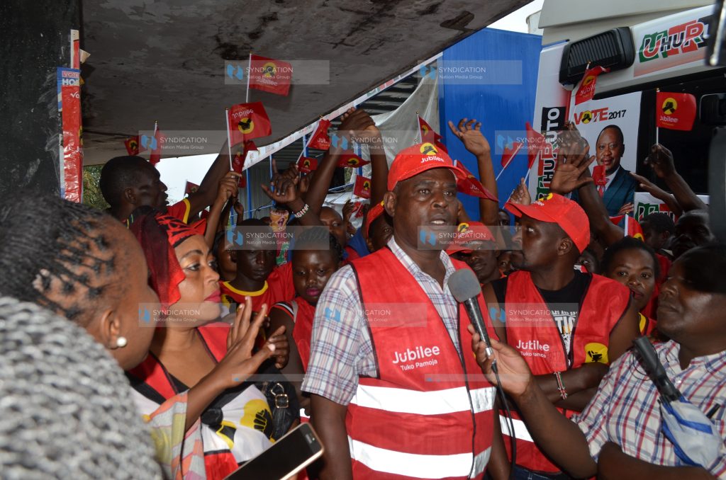 Jubilee Party supporters on a branded caravan