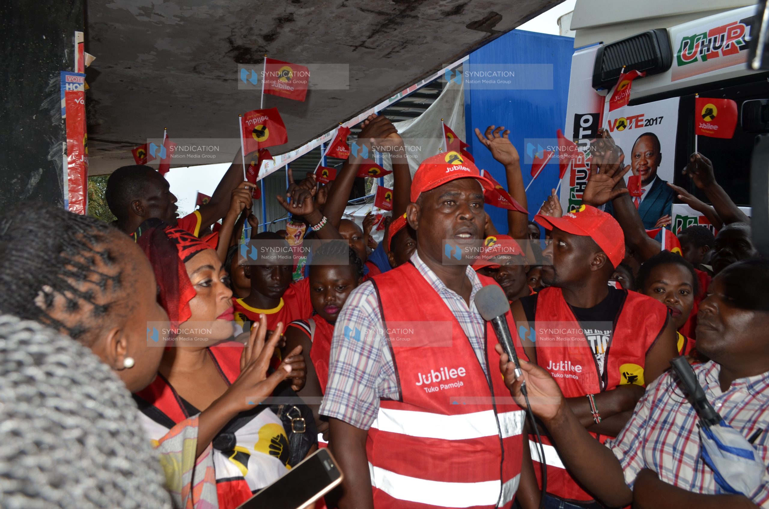 Jubilee Party supporters on a branded caravan