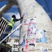 Workers hired by Mombasa Cement remove campaign posters