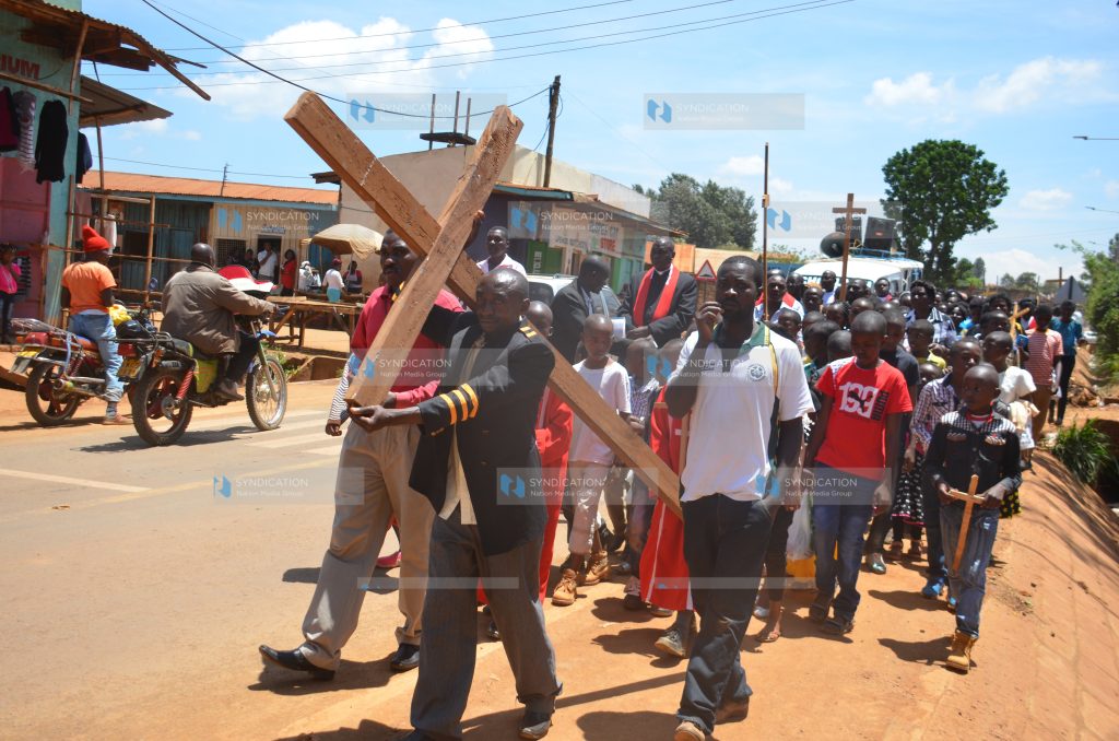 Chuka Town Catholic Church faithfuls carry a holy cross along the streets of Chuka Town