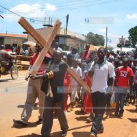 Chuka Town Catholic Church faithfuls carry a holy cross along the streets of Chuka Town
