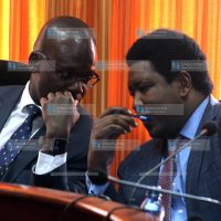 Moses Kajwang' (left) and Narok Senator Ledama Ole Kina shares a word