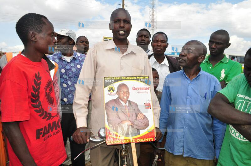 Uasin Gishu County gubernatorial aspirant Solomon Kiptarbei Martim (with bicycle)