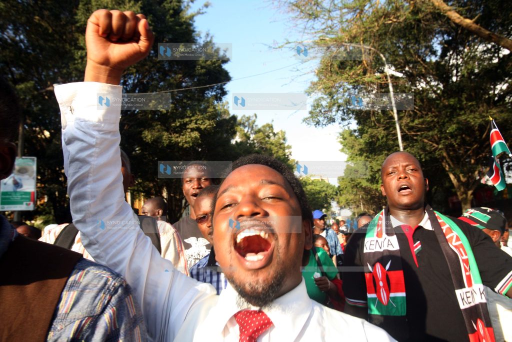 A Man participates in a peaceful demonstration along Nairobi Streets