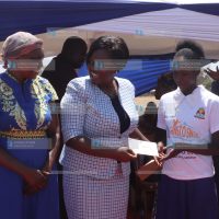Homa Bay Governor Gladys Wanga poses for a photo with beneficiaries of a scholarship programme