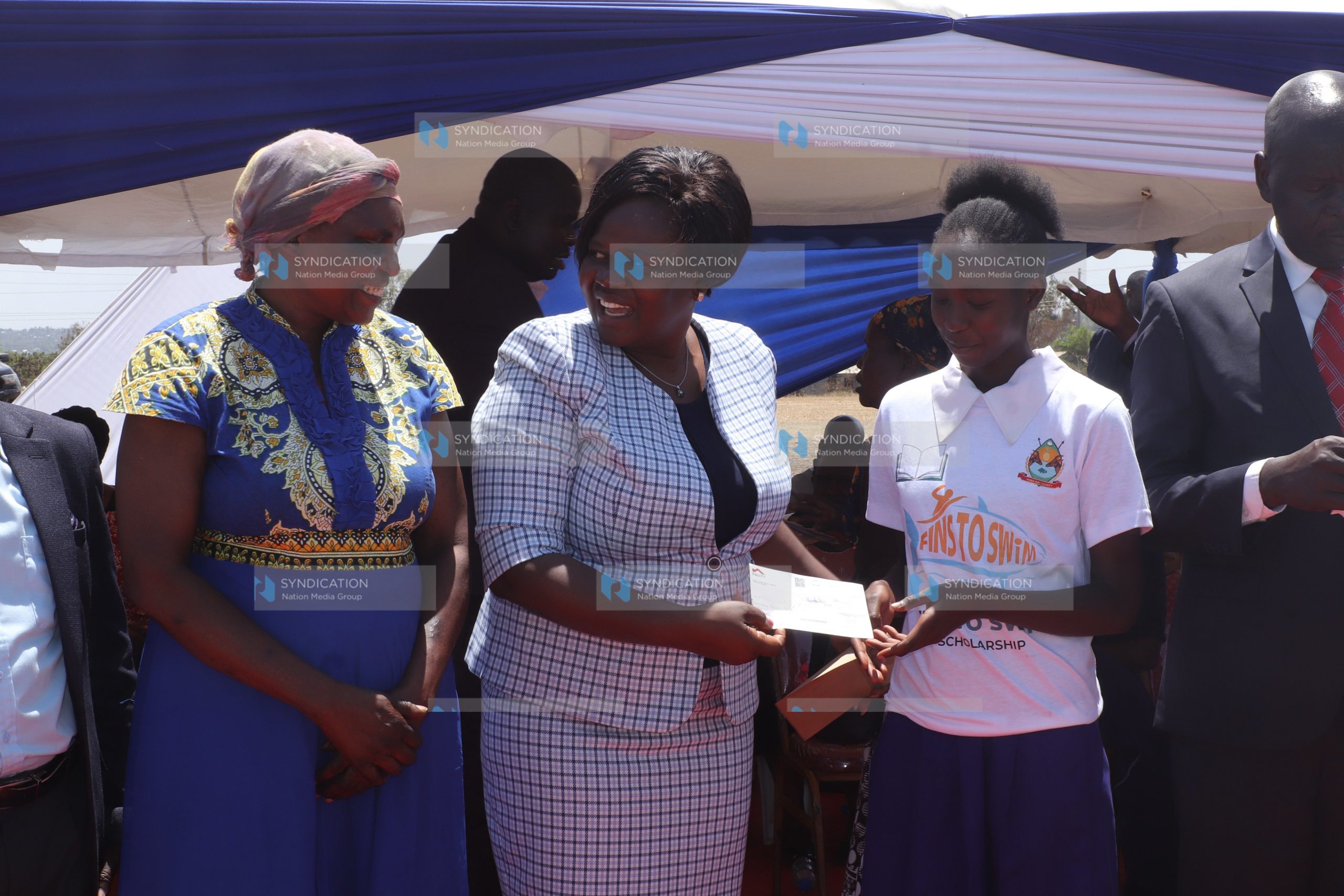 Homa Bay Governor Gladys Wanga poses for a photo with beneficiaries of a scholarship programme