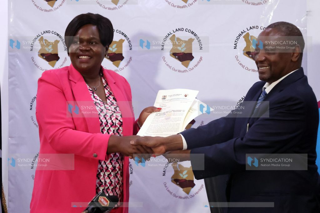 Homabay Governor Gladys Wanga receiving Consent Certificate from NLC Chairman Gershom Otachi