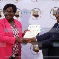 Homabay Governor Gladys Wanga receiving Consent Certificate from NLC Chairman Gershom Otachi