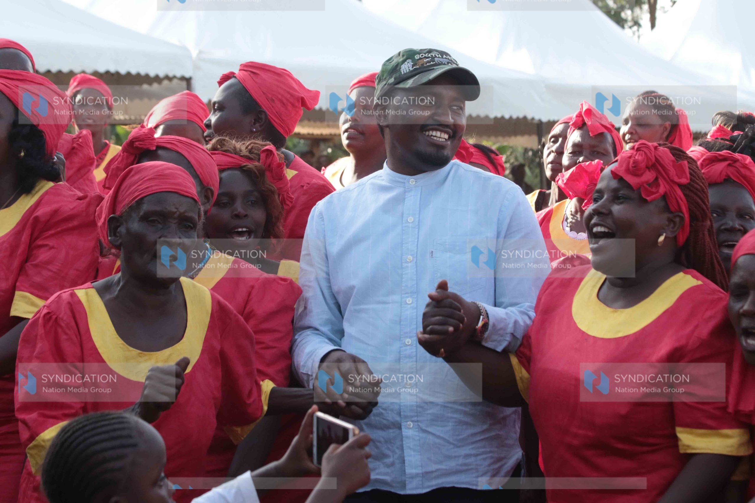 Agriculture Cabinet Secretary Mwangi Kiunjuri joins in a dance during a public participation forum