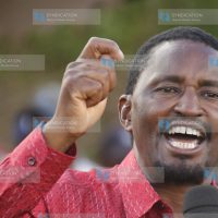 Laikipia East MP Mwangi Kiunjuri stands atop a public address speaker to address residents at Mahiga