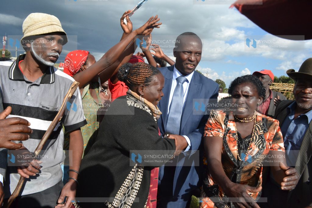Kieni Member of Parliament Nemesyas Warugongo joins in a jig during his campaign meeting