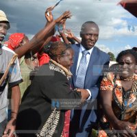 Kieni Member of Parliament Nemesyas Warugongo joins in a jig during his campaign meeting