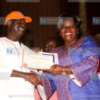 Homa Bay Gubernatorial aspirant Gladys Wanga receiving her nomination certificate from ODM leader Raila Odinga