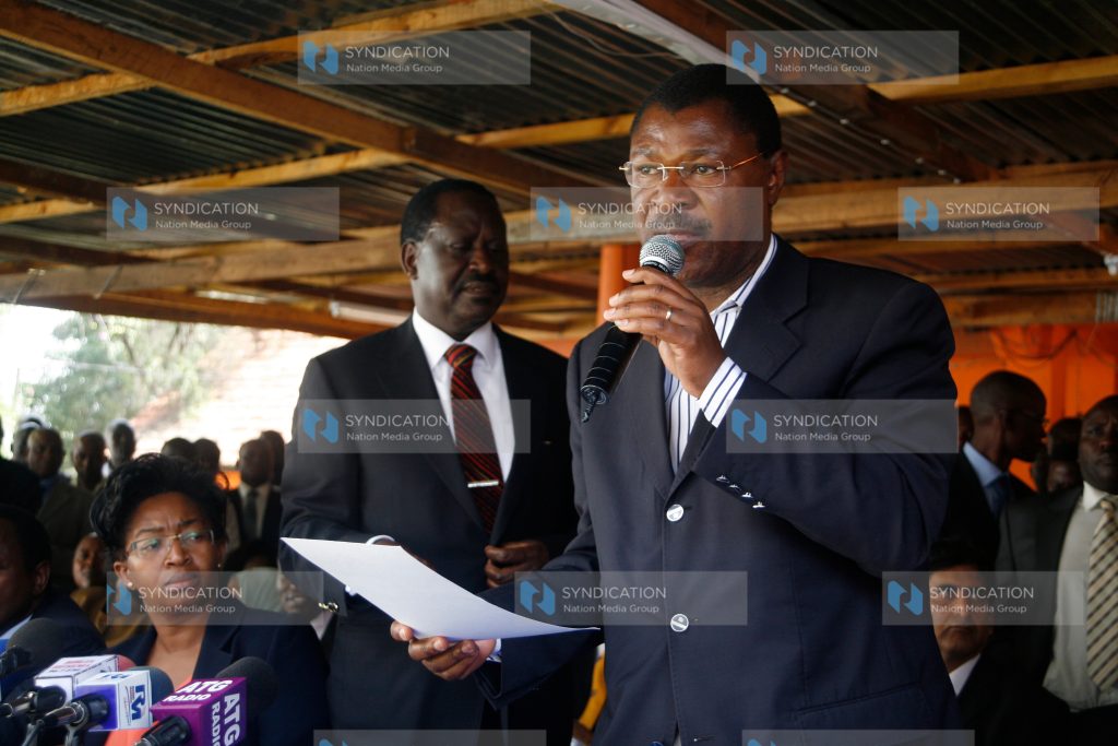 Senator Moses Wetang’ula (right) addresses a news conference