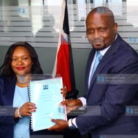 Moses Kuria (right) hands over the Ministry of Investments, Trade and Industry