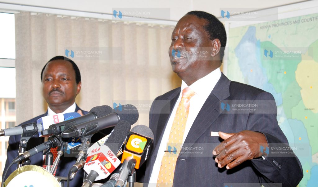 Raila Odinga, accompanied by Moses Wetang’ula and Martha Karua, address the press