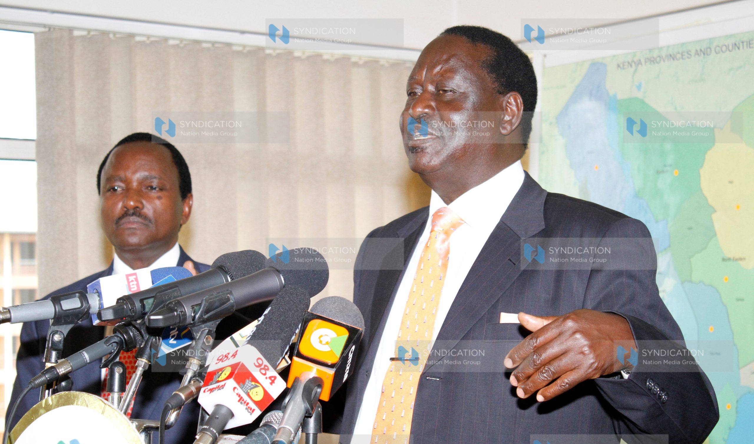 Raila Odinga, accompanied by Moses Wetang’ula and Martha Karua, address the press