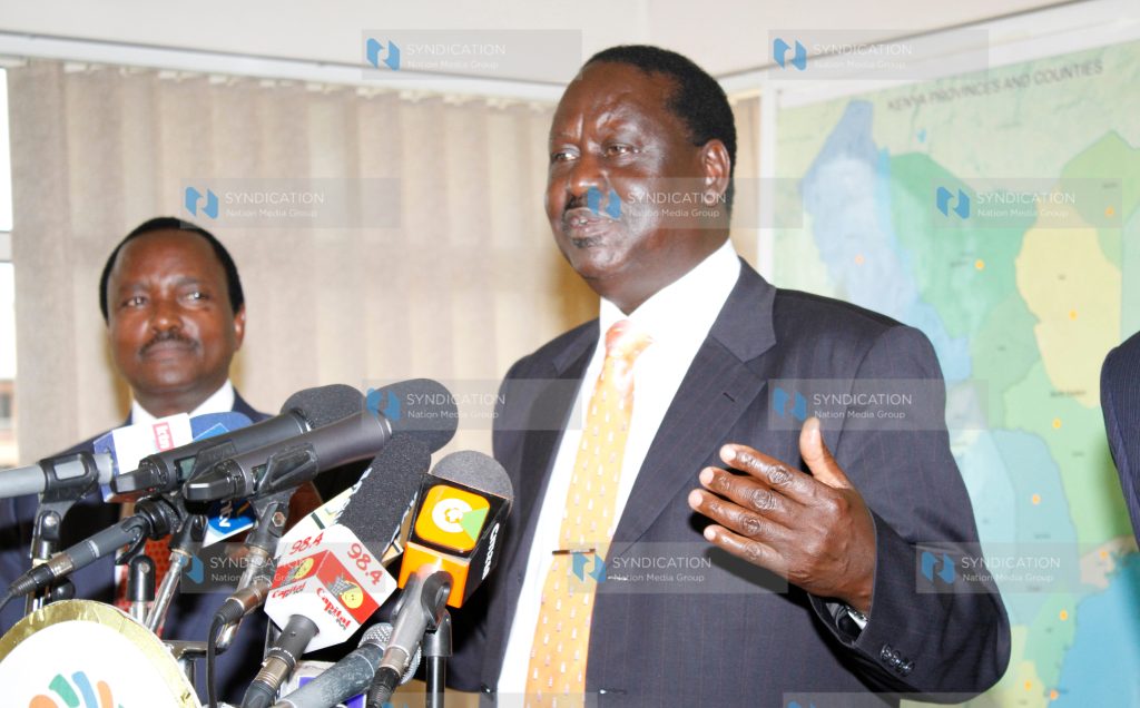 Raila Odinga, accompanied by Moses Wetangula and Martha Karua, address the press