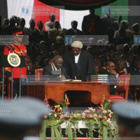 President Mwai Kibaki appends his signature to the new constitution