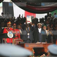 President Mwai Kibaki displays the official new constitution document