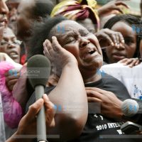 A woman protester cries as they demonstrate outside Nation Centre