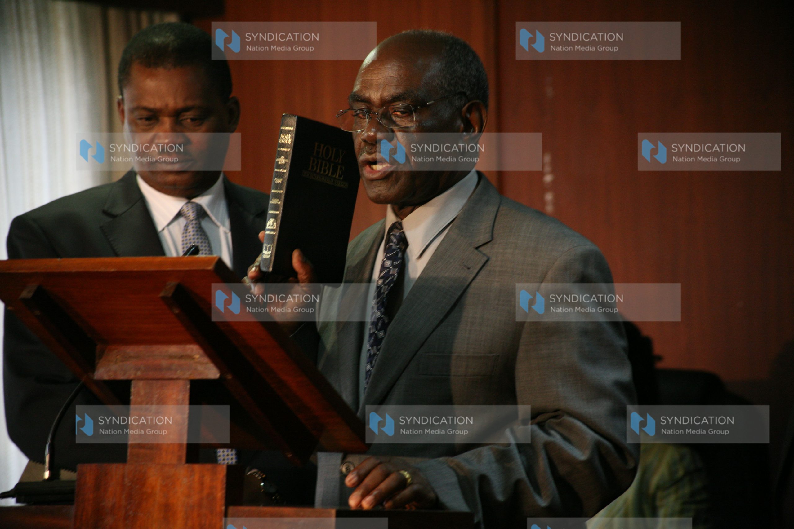 Senator David Musila (right) is sworn in as a member of the Parliamentary Service Commission