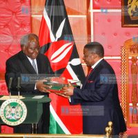 President Mwai Kibaki hands over the original copy of the new constitution