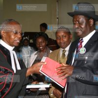 Prime Minister Raila Odinga receives a copy of the Constitution