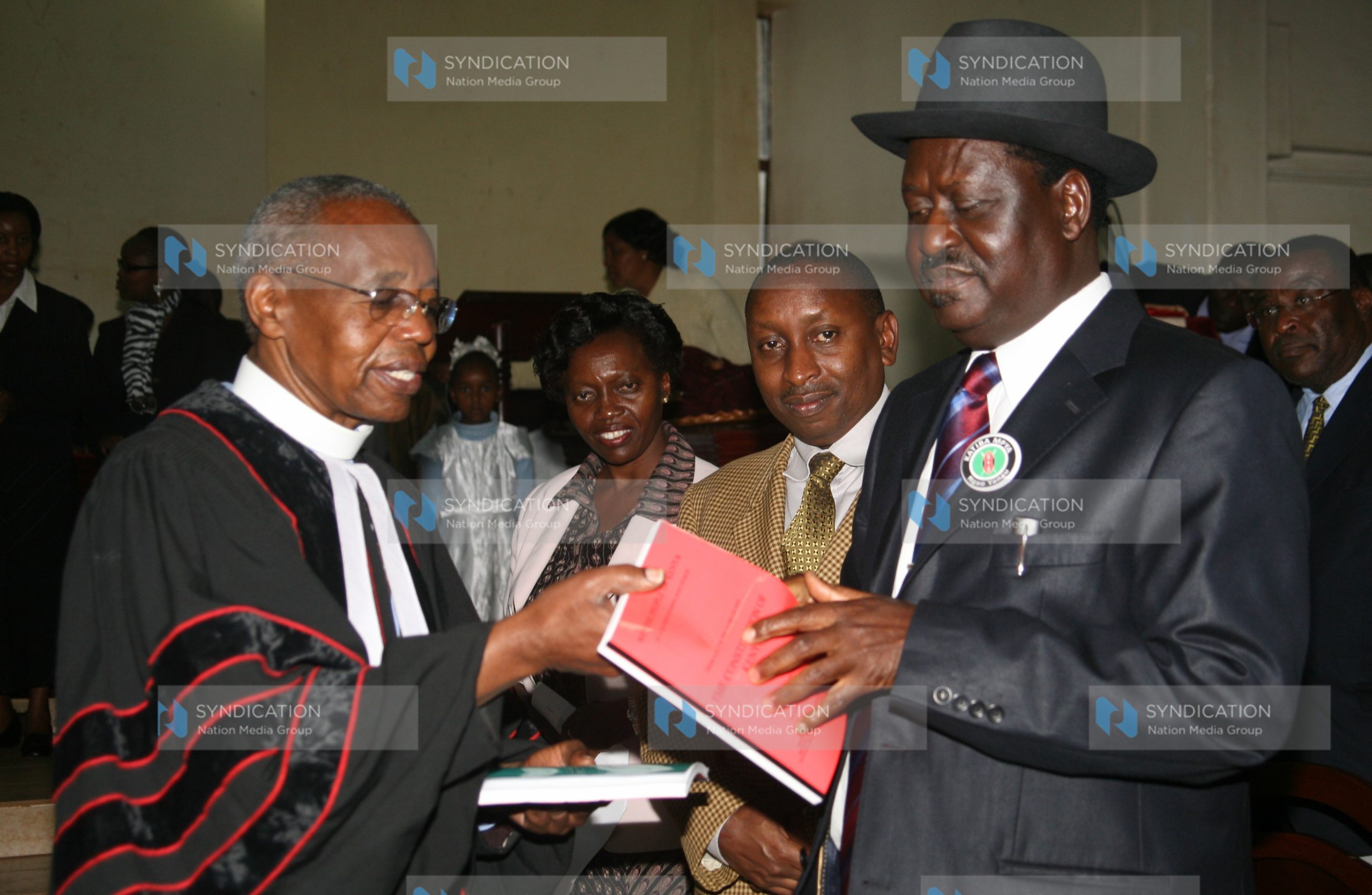 Prime Minister Raila Odinga receives a copy of the Constitution