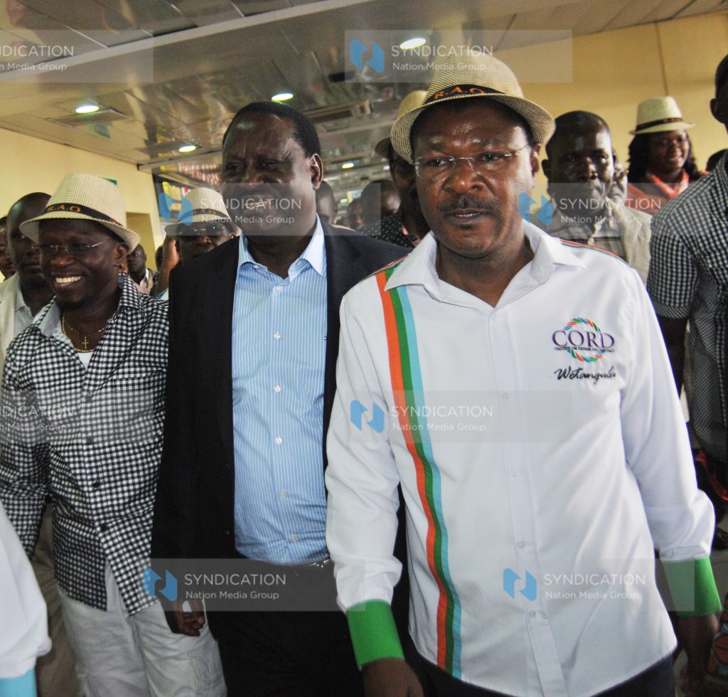 Raila Odinga (centre) with Moses Wetangula (right) and Ababu Namwamba