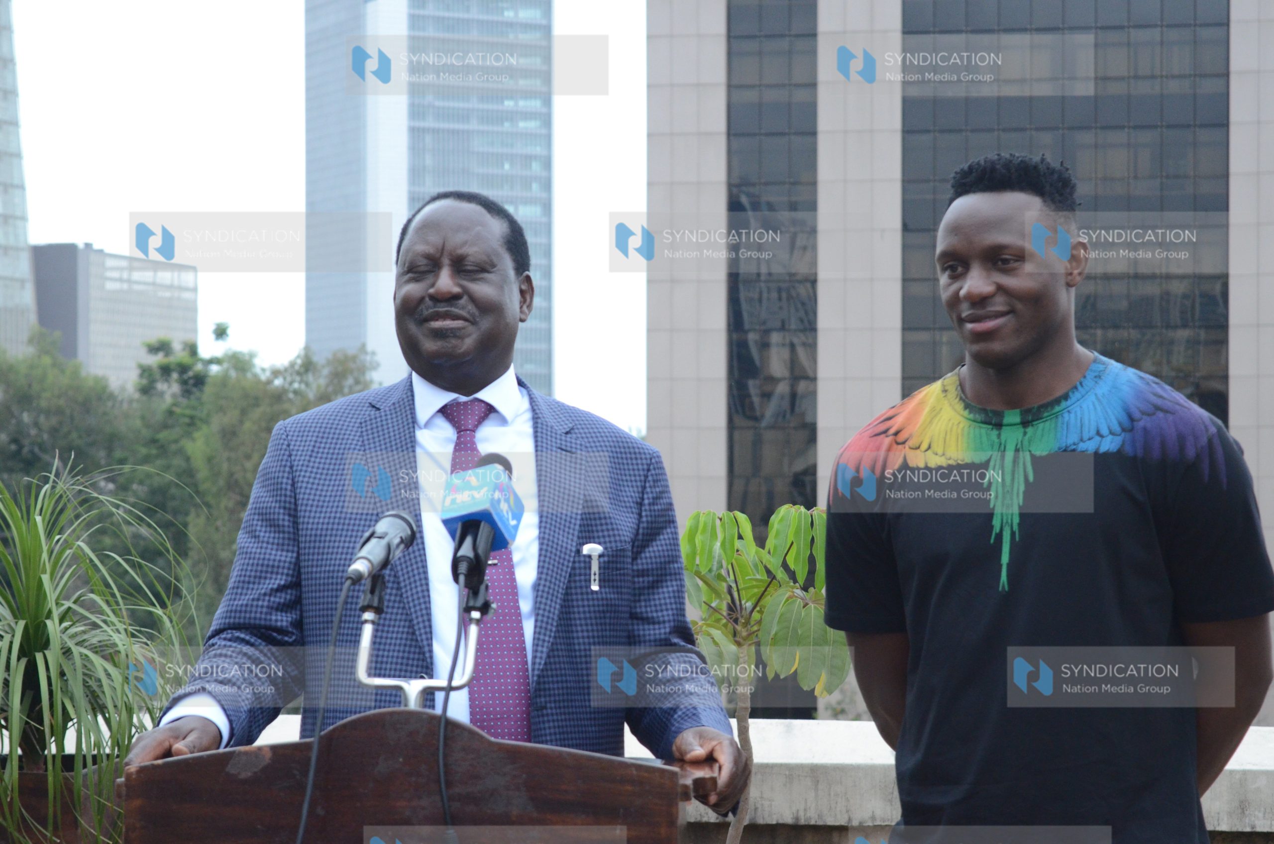 Raila Odinga (left) and Harambee Stars Captain Victor Wanyama address the media at Capitol Hill offices