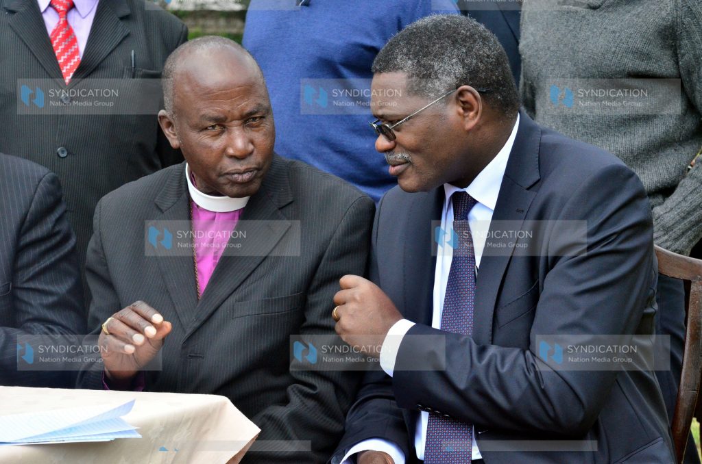 Peter Karanja, Secretary General of the NCCK, confers with Catholic Bishop Alfred Rotic