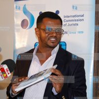 Mombasa Senator Hassan Omar,with a copy of parliamentary watch report