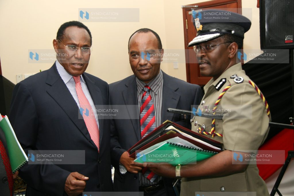 Prof George Saitoti (left) confers with the Permanent Secretary Francis Kimemia (center)