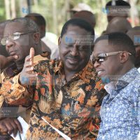 Former Prime Minister Raila Odinga confers with Budalang’i MP Ababu Namwamba