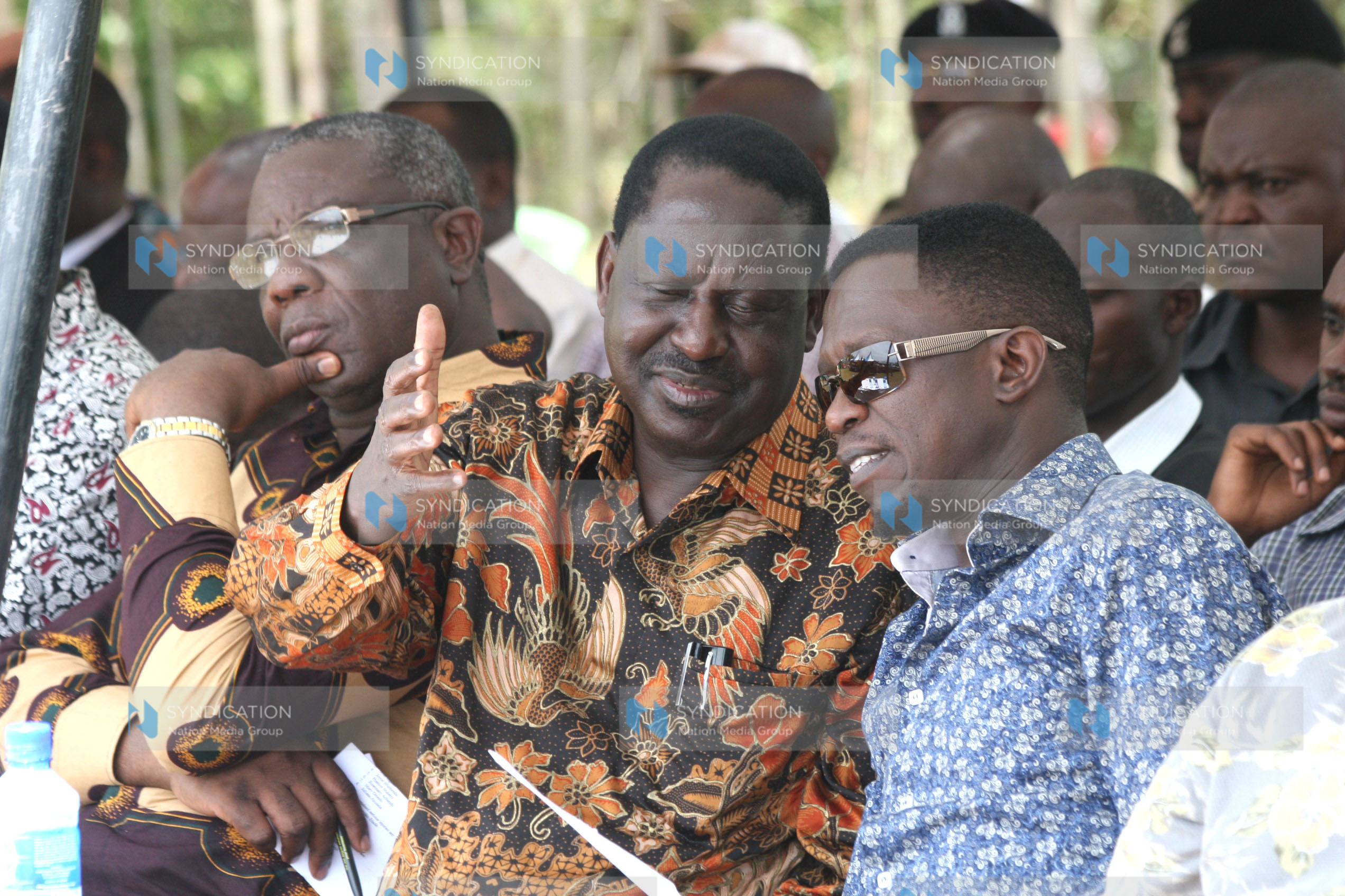 Former Prime Minister Raila Odinga confers with Budalang’i MP Ababu Namwamba