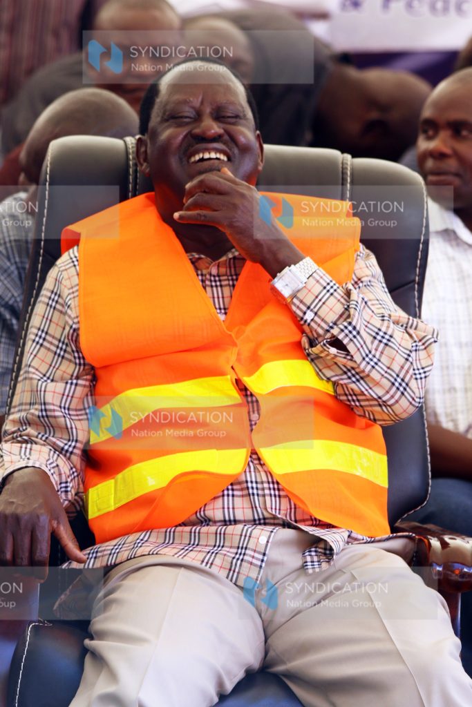 CORD leader Raila Odinga laughs as he follows proceedings
