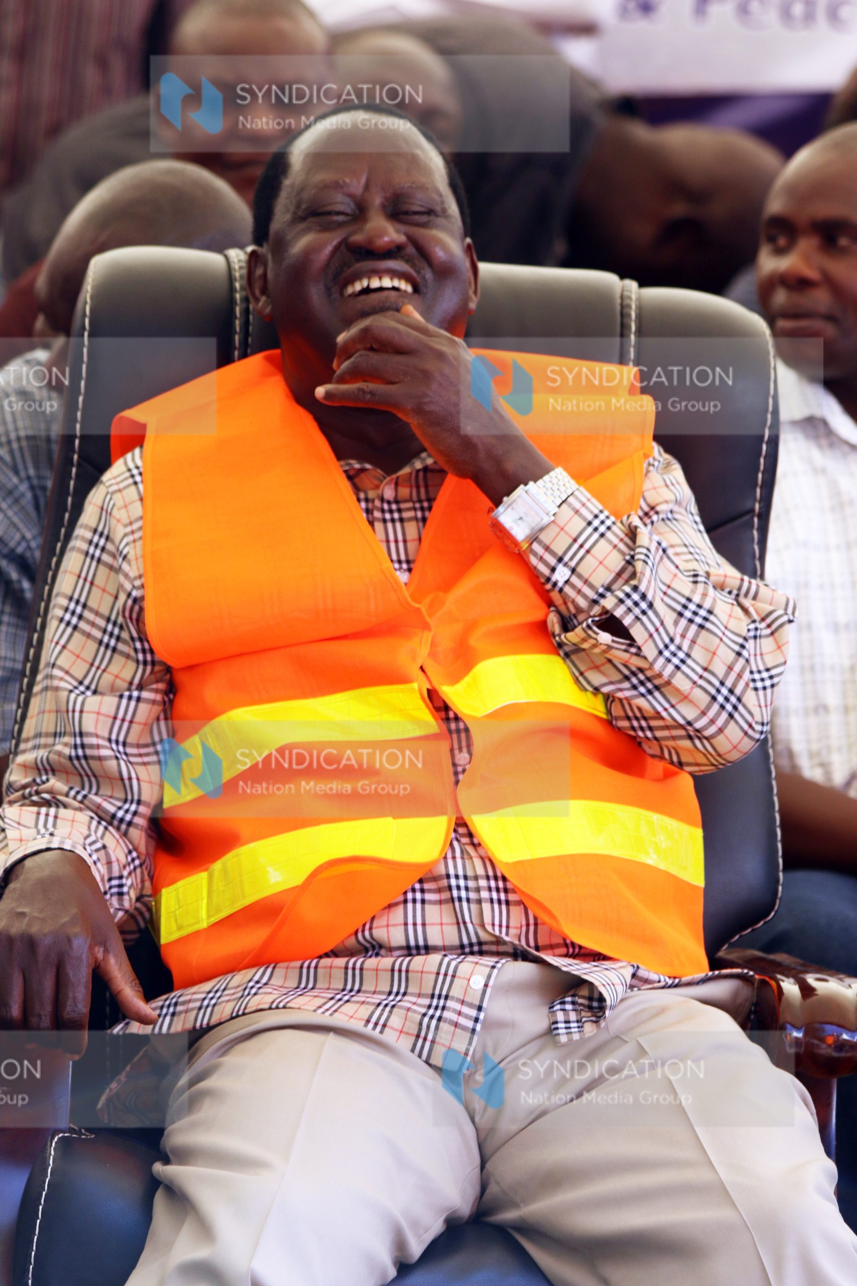 CORD leader Raila Odinga laughs as he follows proceedings