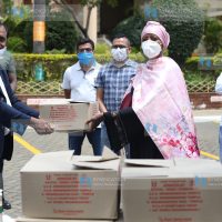 Sports Cabinet Secretary Amina Mohamed receive goods from Narendra Raval
