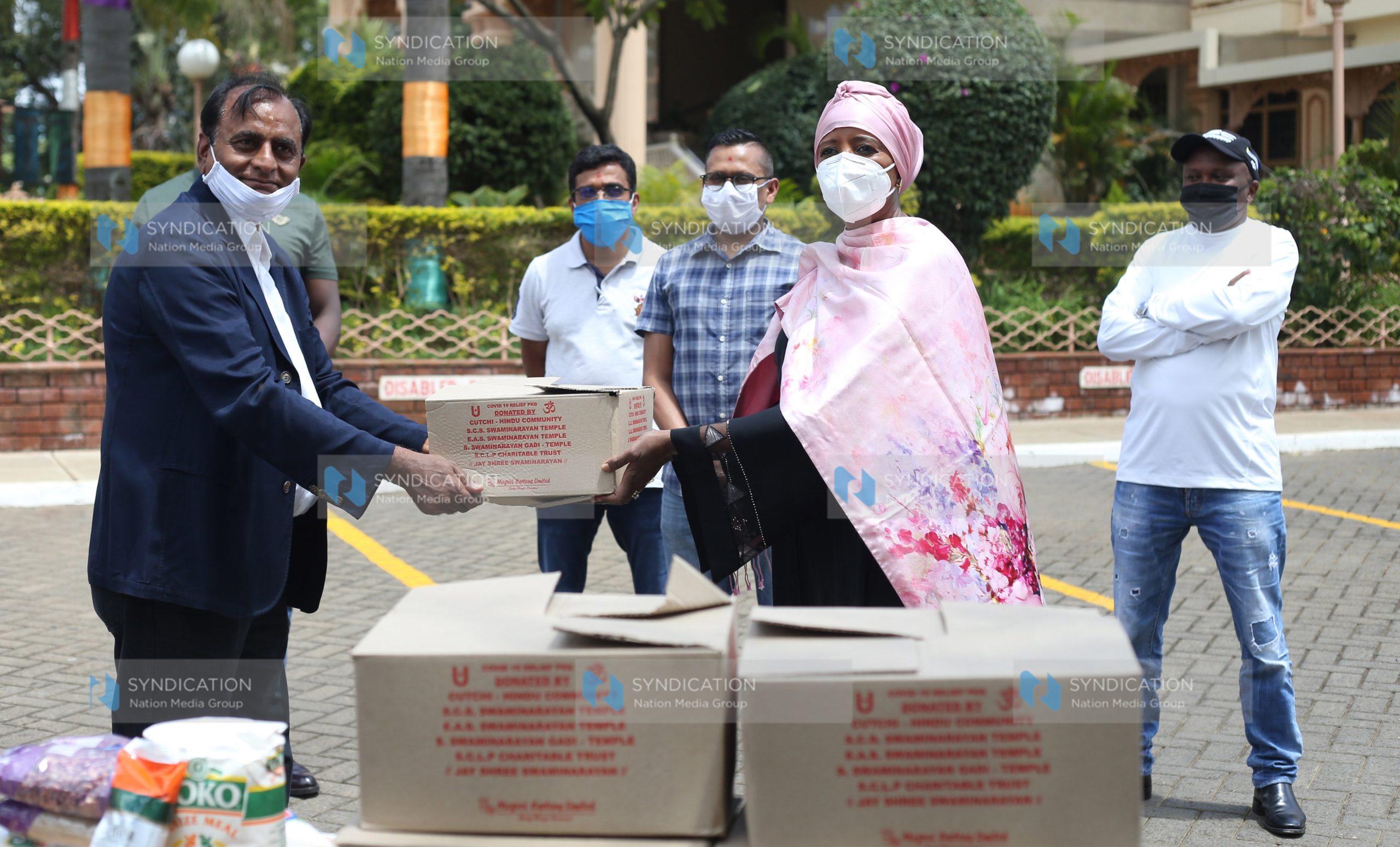 Sports Cabinet Secretary Amina Mohamed receive goods from Narendra Raval