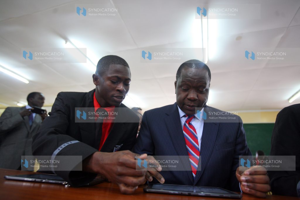Cabinet Secretary for Information, Communication and Technology Dr Fred Matiang’i with Starehe boys centre student Hassan Masha