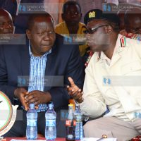 Interior acting Cabinet secretary Dr. Fred Matiang’i consults with Nyanza regional coordinator Wilson Njega