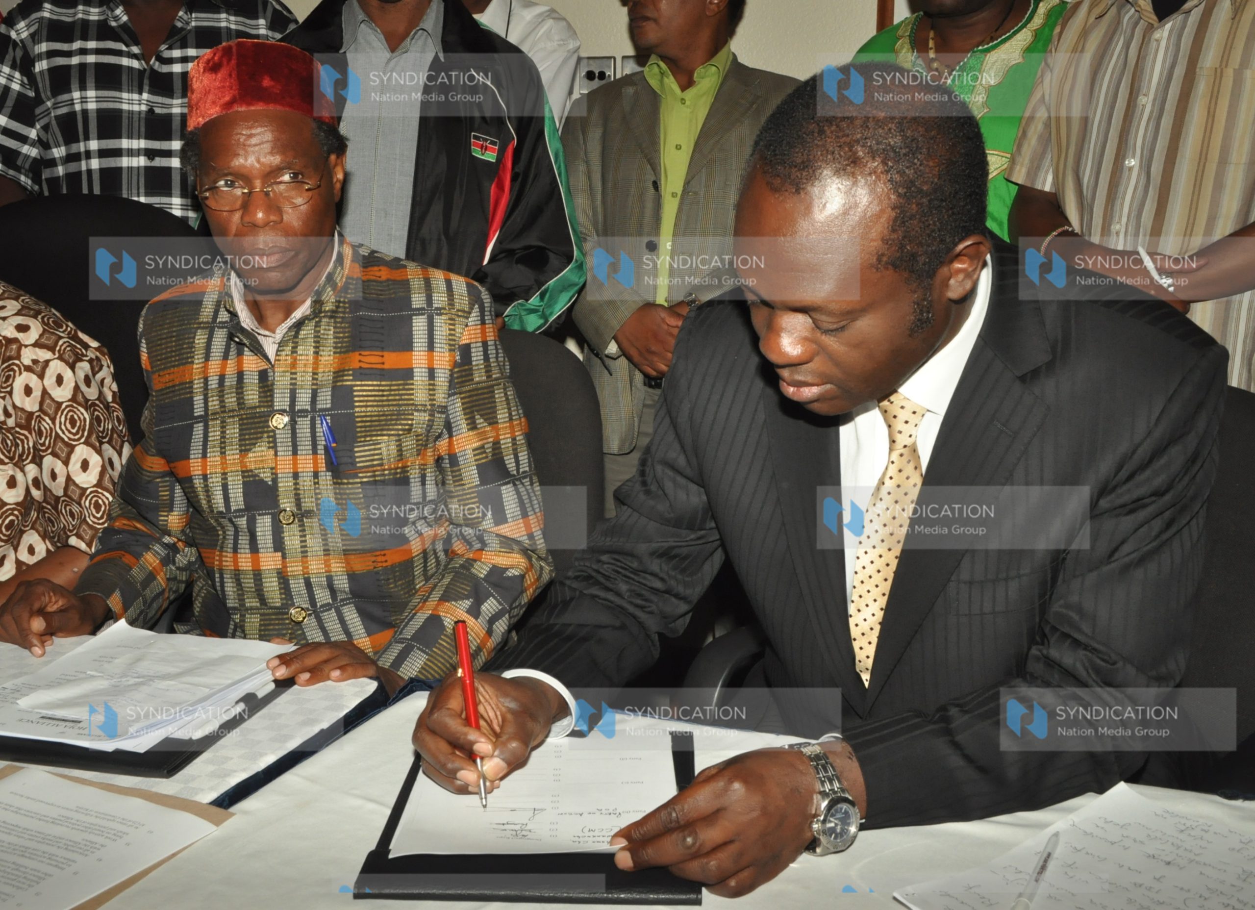 Raphael Tuju and Koigi Wamwere when they signed a Memorandum of Agreement